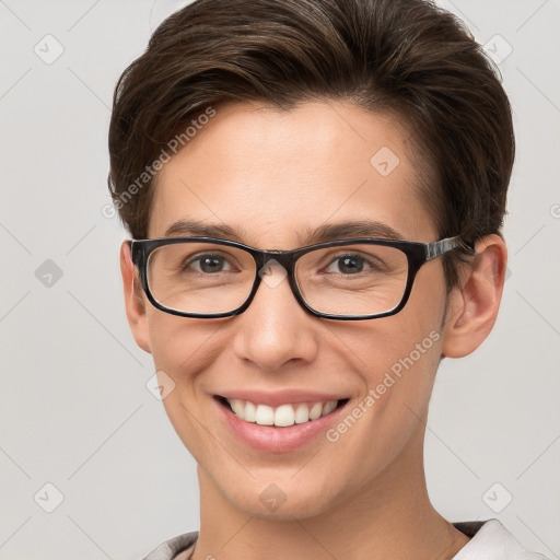 Joyful white young-adult female with short  brown hair and grey eyes