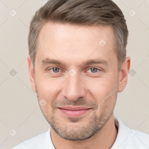 Joyful white adult male with short  brown hair and grey eyes