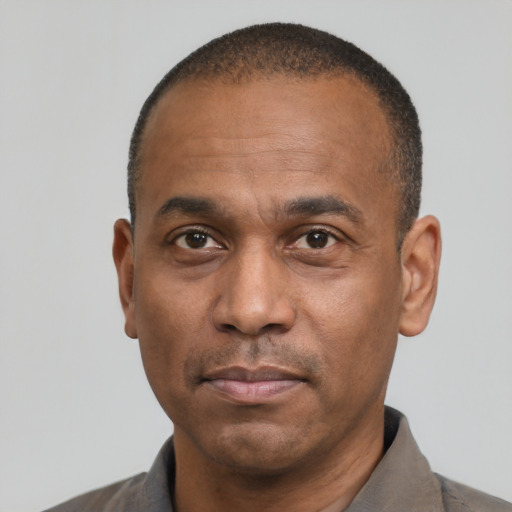 Neutral latino adult male with short  black hair and brown eyes