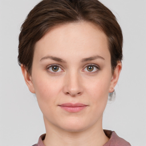 Joyful white young-adult female with short  brown hair and green eyes