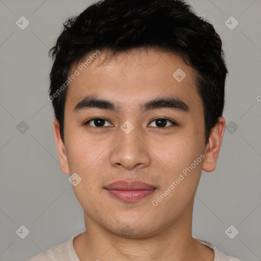 Joyful asian young-adult male with short  black hair and brown eyes