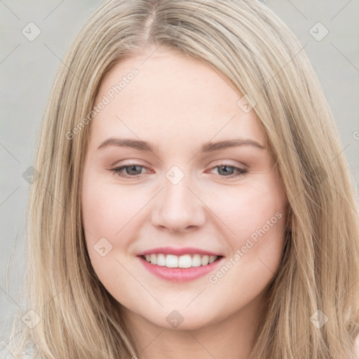 Joyful white young-adult female with long  brown hair and blue eyes