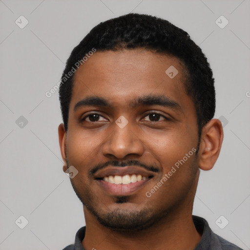 Joyful black young-adult male with short  black hair and brown eyes