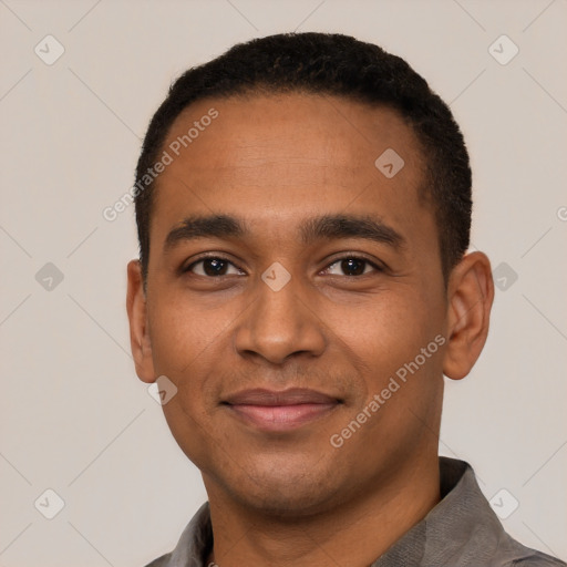 Joyful black young-adult male with short  black hair and brown eyes