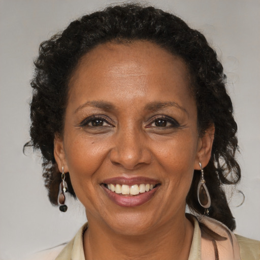 Joyful black adult female with medium  brown hair and brown eyes