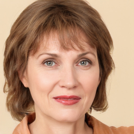 Joyful white adult female with medium  brown hair and grey eyes