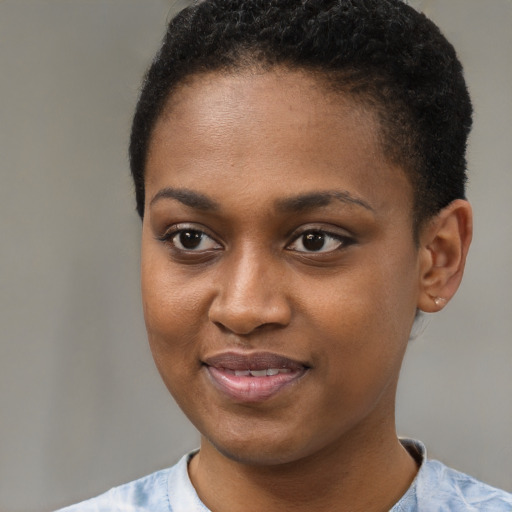 Joyful black young-adult female with short  brown hair and brown eyes