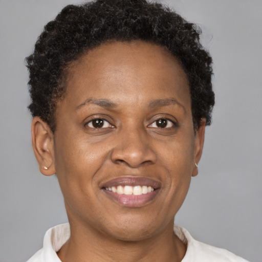 Joyful black adult female with short  brown hair and brown eyes
