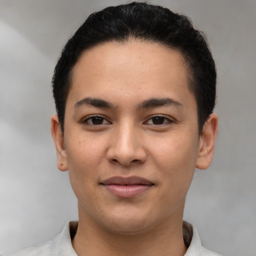 Joyful latino young-adult male with short  brown hair and brown eyes