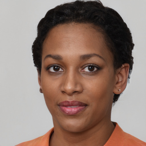 Joyful latino young-adult female with short  black hair and brown eyes