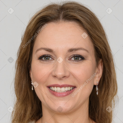 Joyful white adult female with long  brown hair and green eyes