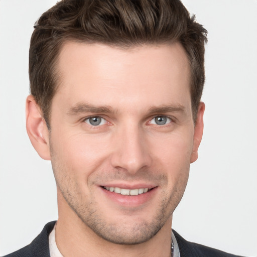 Joyful white young-adult male with short  brown hair and grey eyes