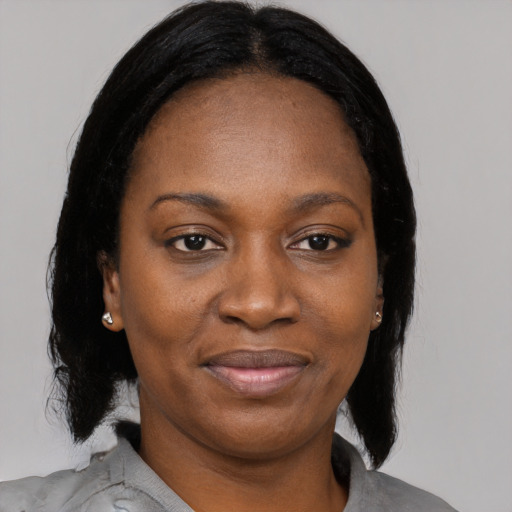 Joyful black young-adult female with medium  black hair and brown eyes