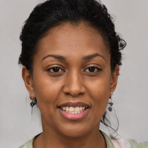 Joyful latino adult female with short  brown hair and brown eyes