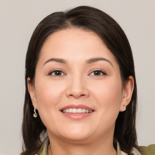 Joyful white young-adult female with medium  brown hair and brown eyes