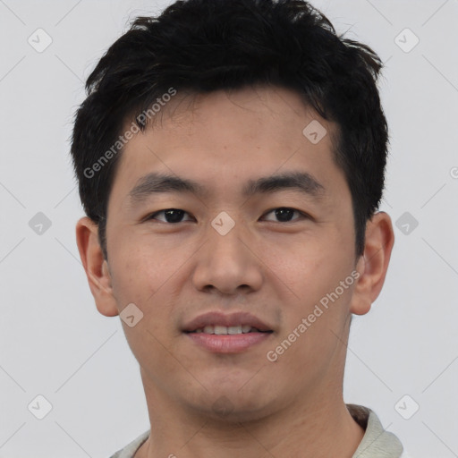 Joyful asian young-adult male with short  black hair and brown eyes