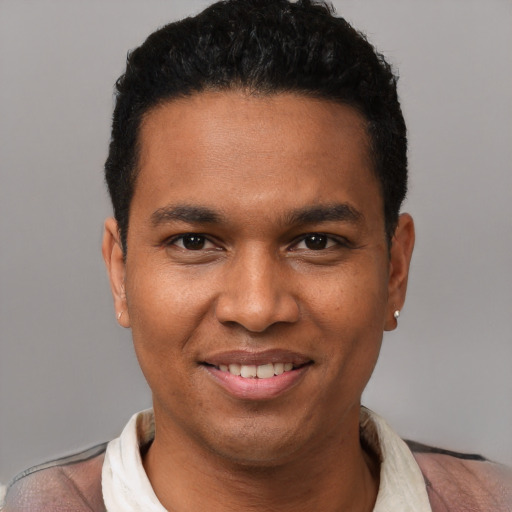 Joyful black young-adult male with short  black hair and brown eyes