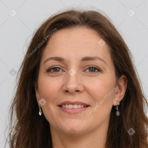 Joyful white adult female with long  brown hair and grey eyes