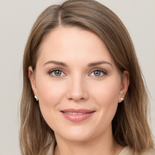 Joyful white young-adult female with long  brown hair and grey eyes