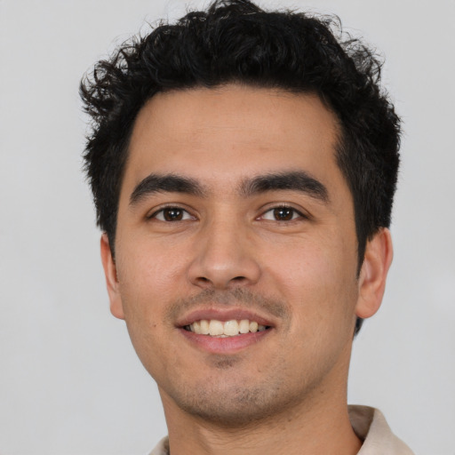 Joyful latino young-adult male with short  brown hair and brown eyes