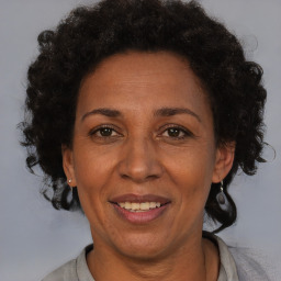 Joyful black adult female with short  brown hair and brown eyes