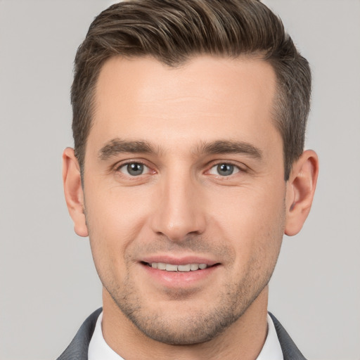 Joyful white young-adult male with short  brown hair and brown eyes