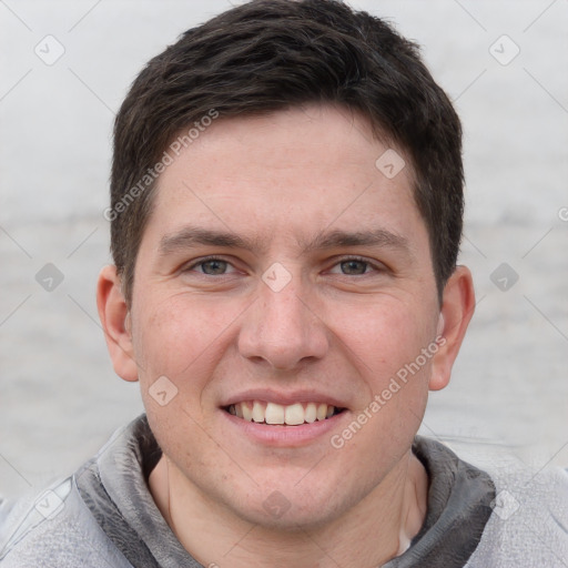 Joyful white adult male with short  brown hair and grey eyes