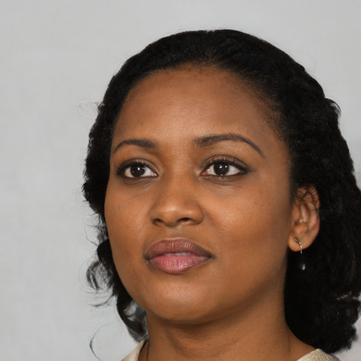 Joyful black young-adult female with medium  black hair and brown eyes