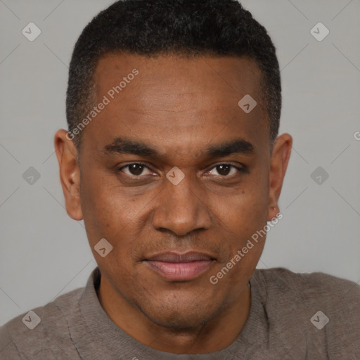 Joyful black young-adult male with short  brown hair and brown eyes