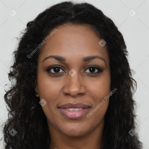 Joyful black young-adult female with long  brown hair and brown eyes