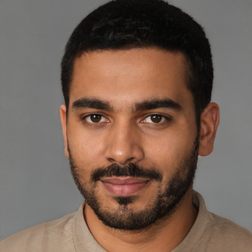 Joyful latino young-adult male with short  black hair and brown eyes