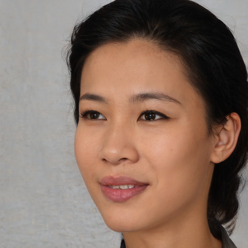 Joyful asian young-adult female with medium  brown hair and brown eyes