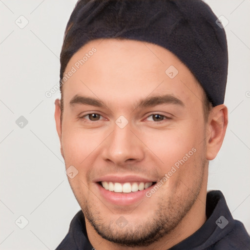 Joyful white young-adult male with short  brown hair and brown eyes