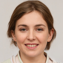 Joyful white young-adult female with medium  brown hair and grey eyes