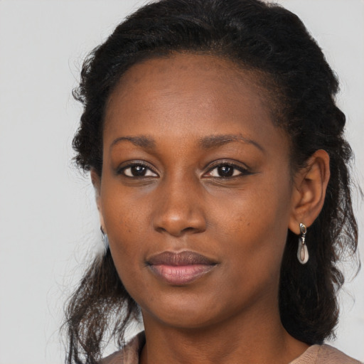 Neutral black young-adult female with long  brown hair and brown eyes