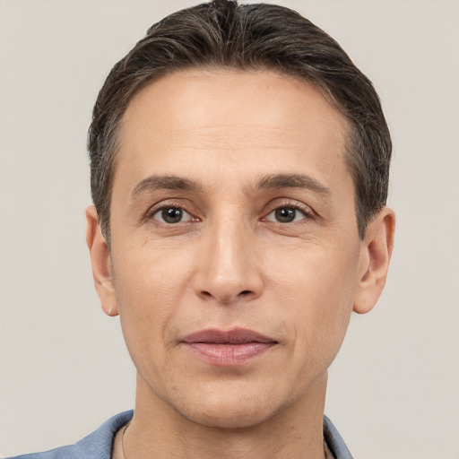 Joyful white adult male with short  brown hair and brown eyes