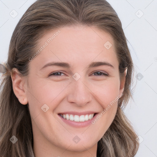 Joyful white young-adult female with long  brown hair and blue eyes