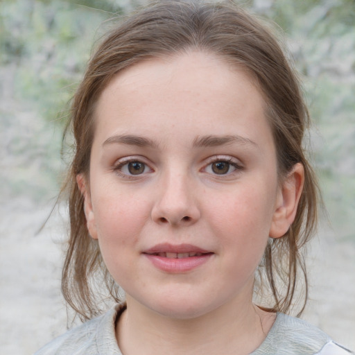 Joyful white child female with medium  brown hair and grey eyes