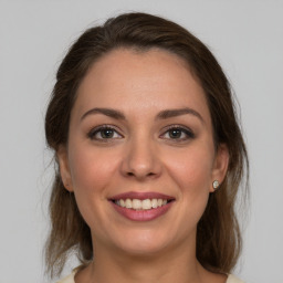 Joyful white young-adult female with medium  brown hair and brown eyes