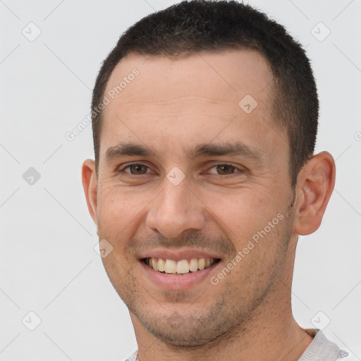 Joyful white young-adult male with short  brown hair and brown eyes