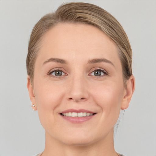 Joyful white young-adult female with short  brown hair and grey eyes