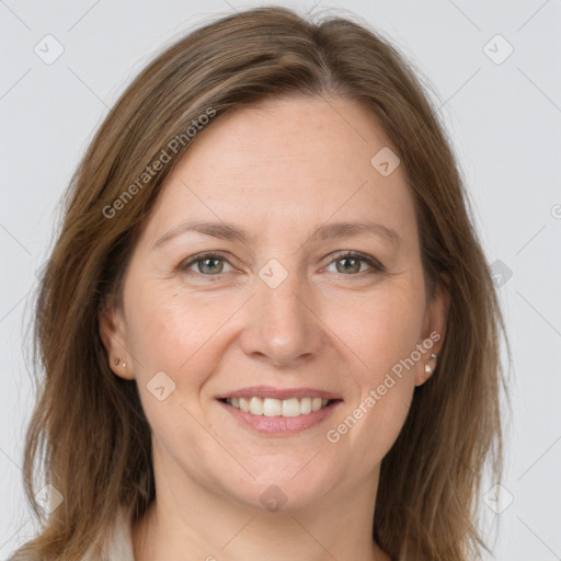 Joyful white adult female with medium  brown hair and grey eyes