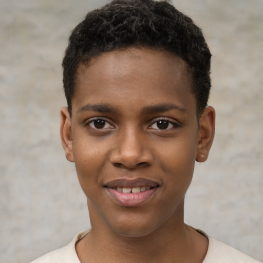 Joyful black child male with short  black hair and brown eyes