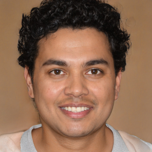 Joyful latino young-adult male with short  brown hair and brown eyes