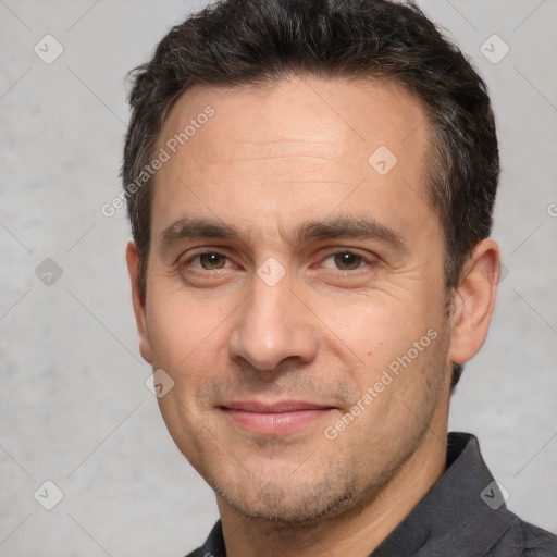 Joyful white adult male with short  brown hair and brown eyes