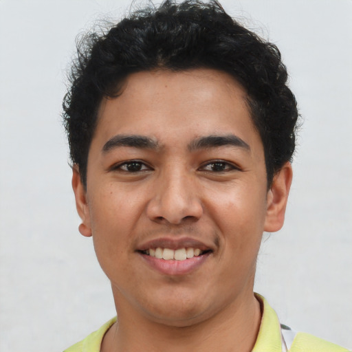 Joyful latino young-adult male with short  black hair and brown eyes