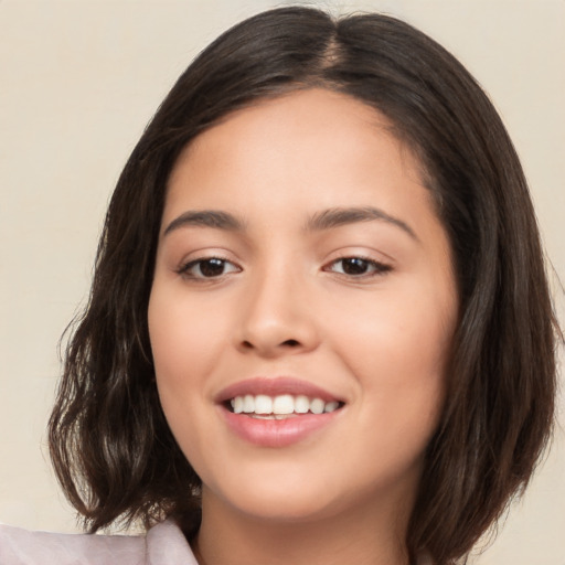 Joyful white young-adult female with medium  brown hair and brown eyes