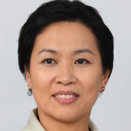 Joyful asian adult female with short  brown hair and brown eyes