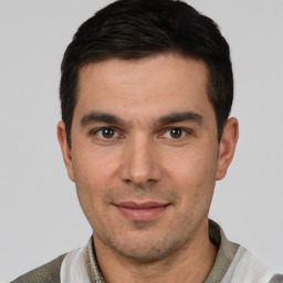 Joyful white young-adult male with short  black hair and brown eyes