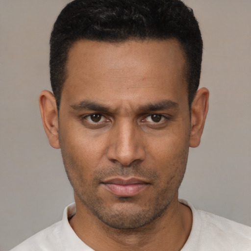 Neutral latino young-adult male with short  black hair and brown eyes